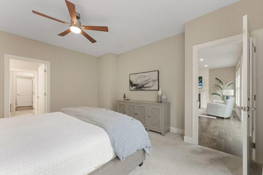 Another view of the primary bedroom suite. It's situated near the main floor living room and the slider door to access the deck.