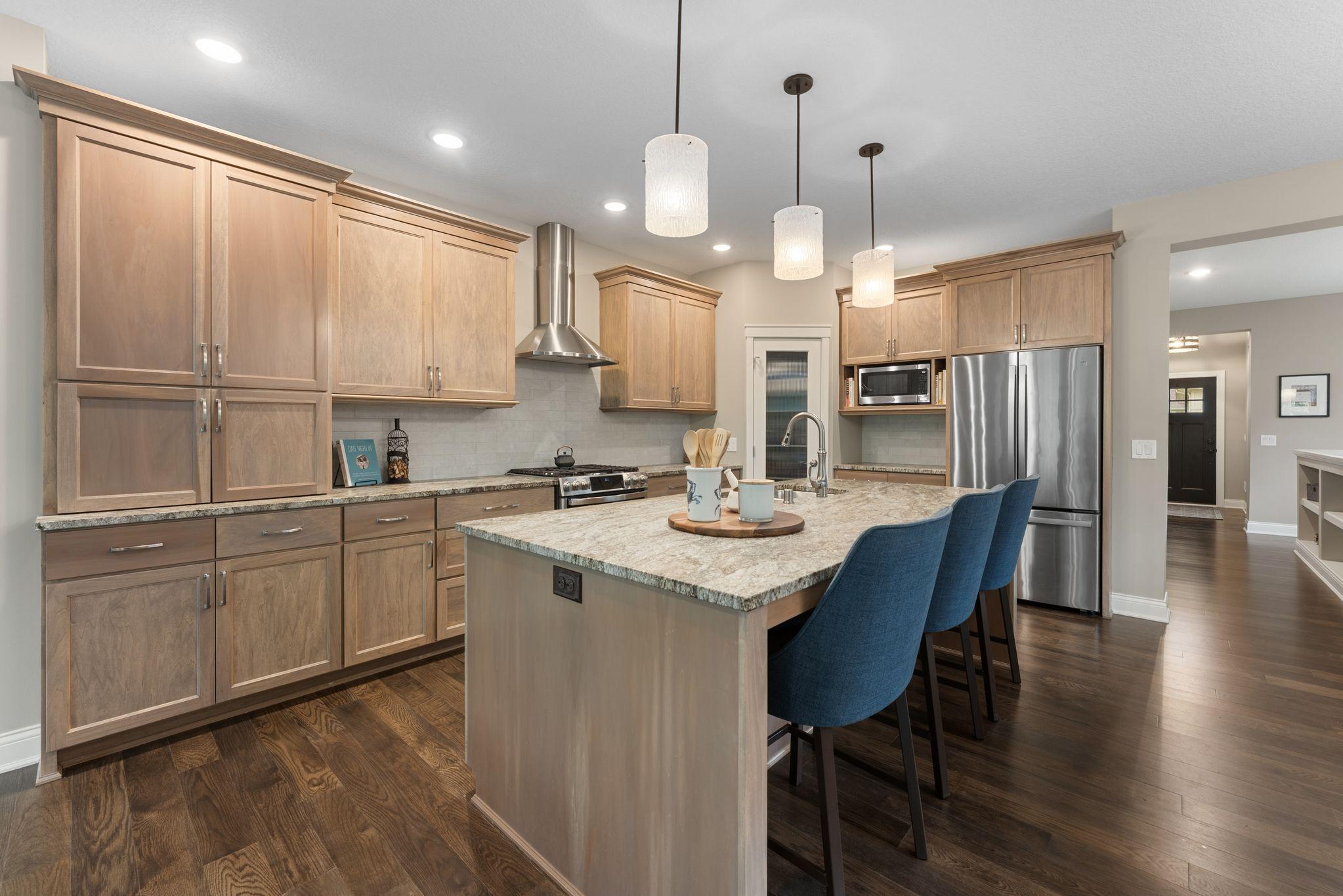 The extended cabinetry and larger/upgraded island provides a place for you to continue the conversation while you entertain! Your guests can have a seat while the main entree is finishing up!