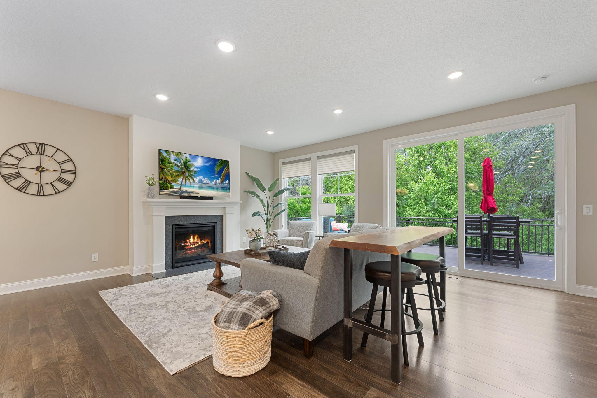 Did I mention the lot overlooks a peaceful, wooded lot? The slider door leads to an upgraded, extended, entertainment-sized maintenance-free deck!