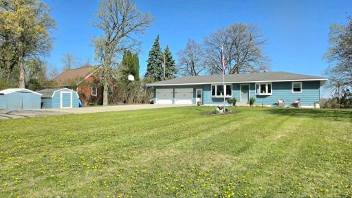 Two stall attached garage with two additional storage sheds for all your lake gear
