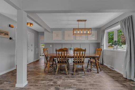 Large designated dinning space with wainscotting accents and another bay window to bring in natural light