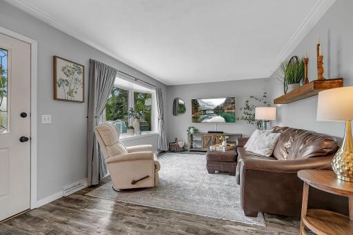 Enter into the bright main floor living room with huge bay window