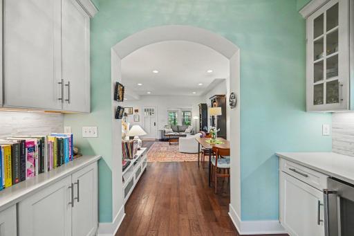 Walk through pantry area with glass shelves, wine refrigerator....counter space.