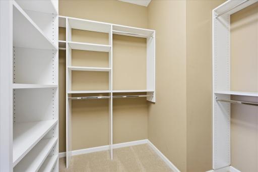 Primary walk in organized closet just off the bath