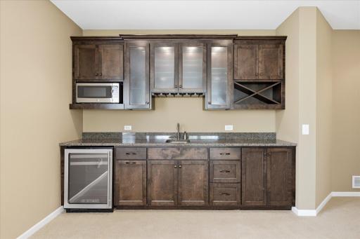 Wet bar features a U-line bar/wine frig, beautiful rich cabinets including some display cabinets, plus micro wave