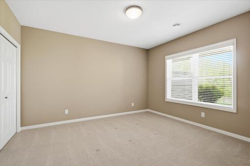 Bedroom 2 on lower level has large windows looking out back