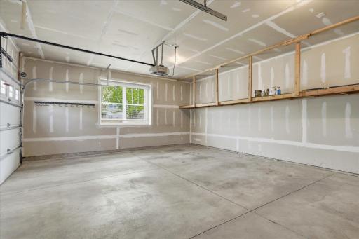 another pic of the garage showing the built in shelf across the back. walls are all sheetrocked