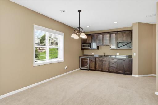 This large open area would be great for any kind of game table with the very nice walk up wet bar