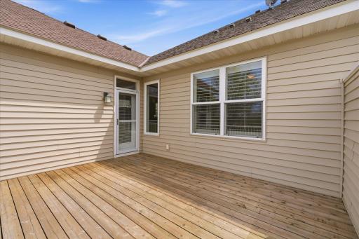 This photo shows the size of the deck, door to great room and windows from primary bedroom