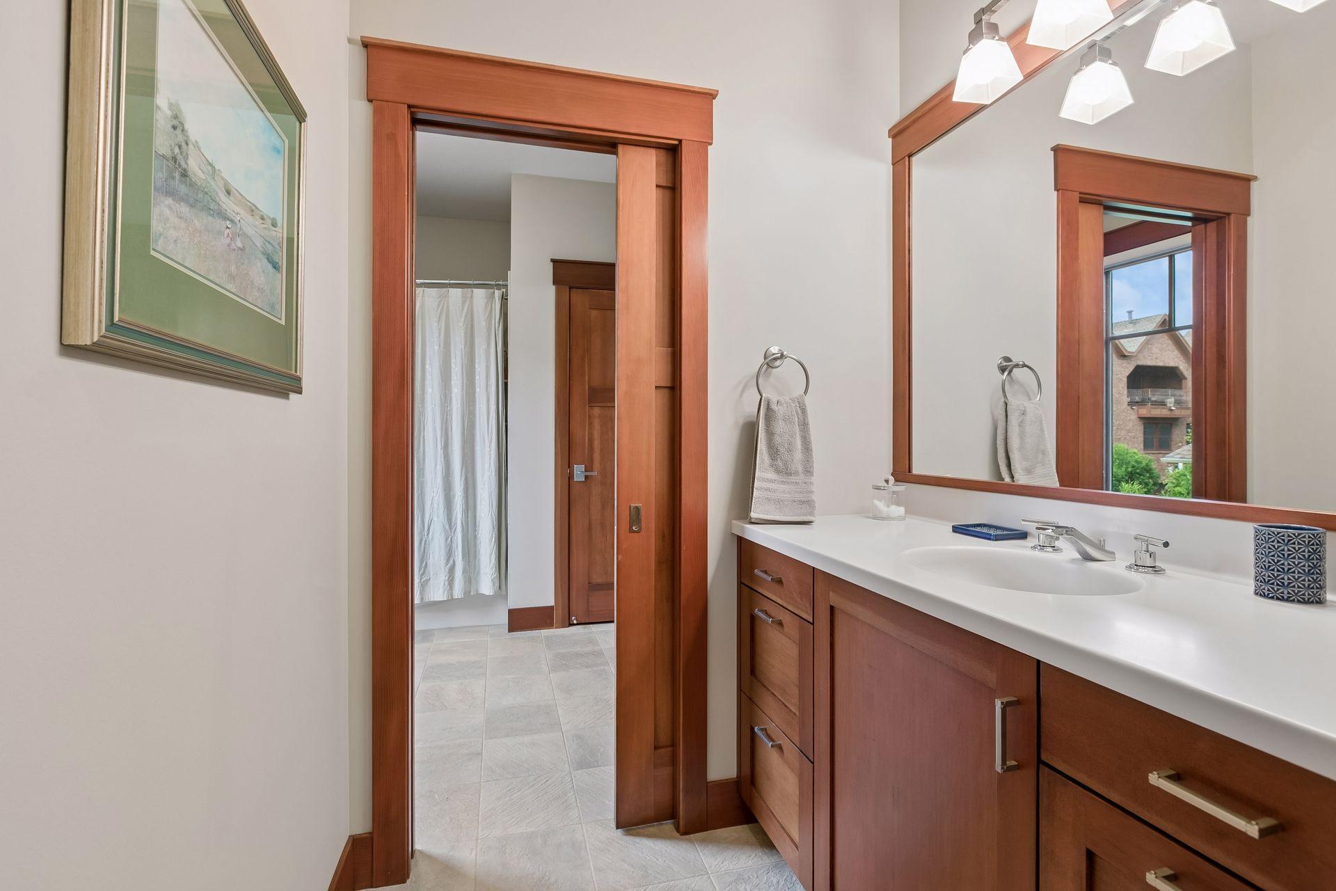 Bedroom 2 offers direct access to a Jack-and-Jill full bath with private vanity area.