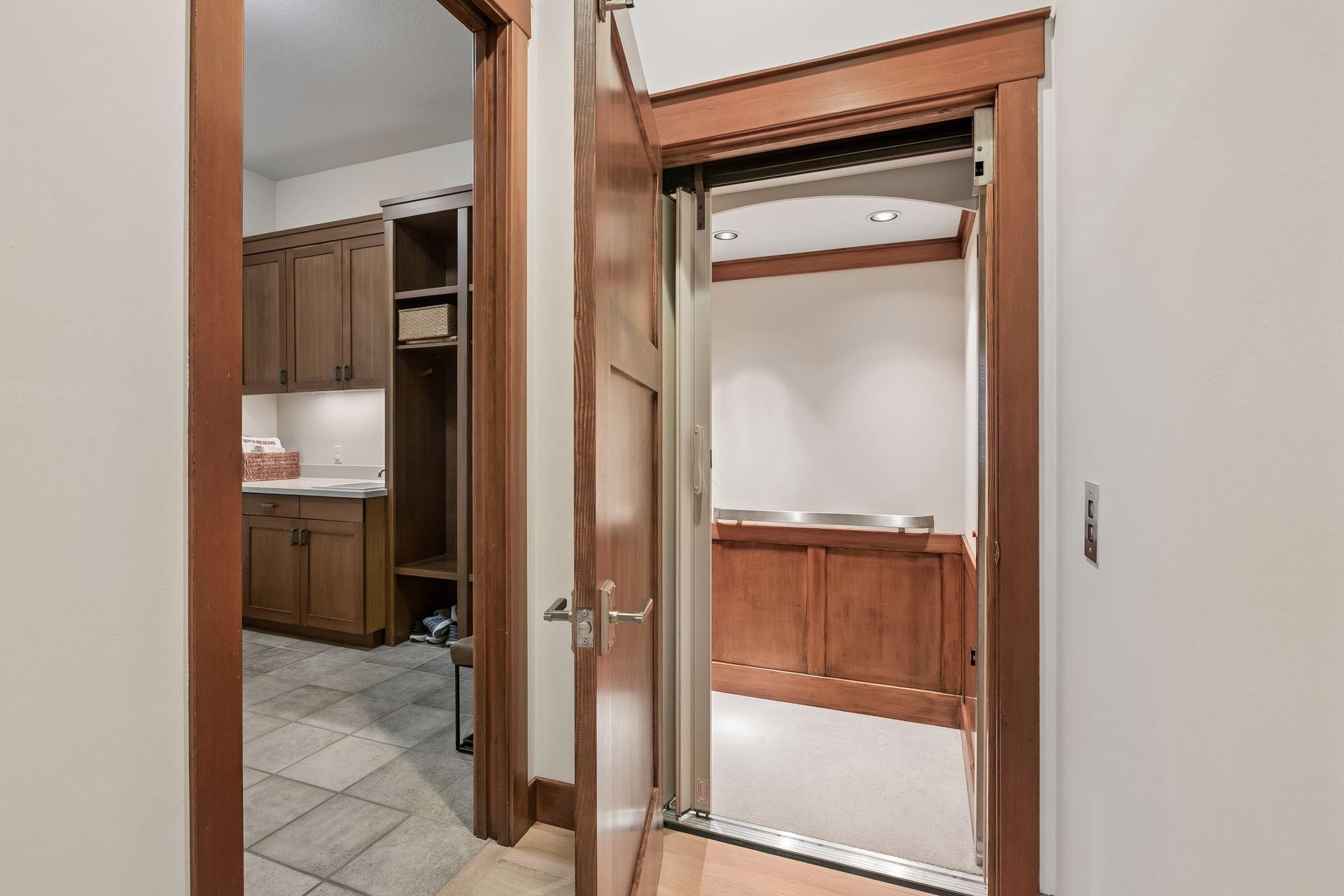 Elevator accommodating two passengers with wheelchair accessibility.