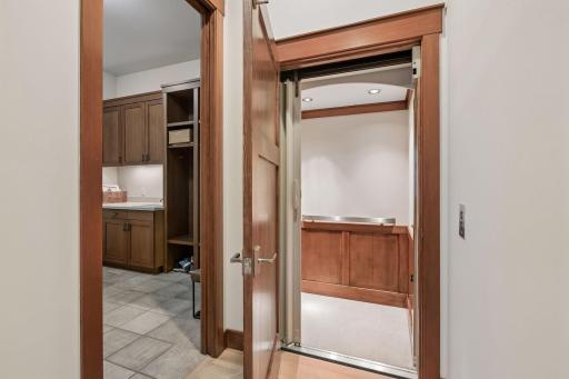 Elevator accommodating two passengers with wheelchair accessibility.