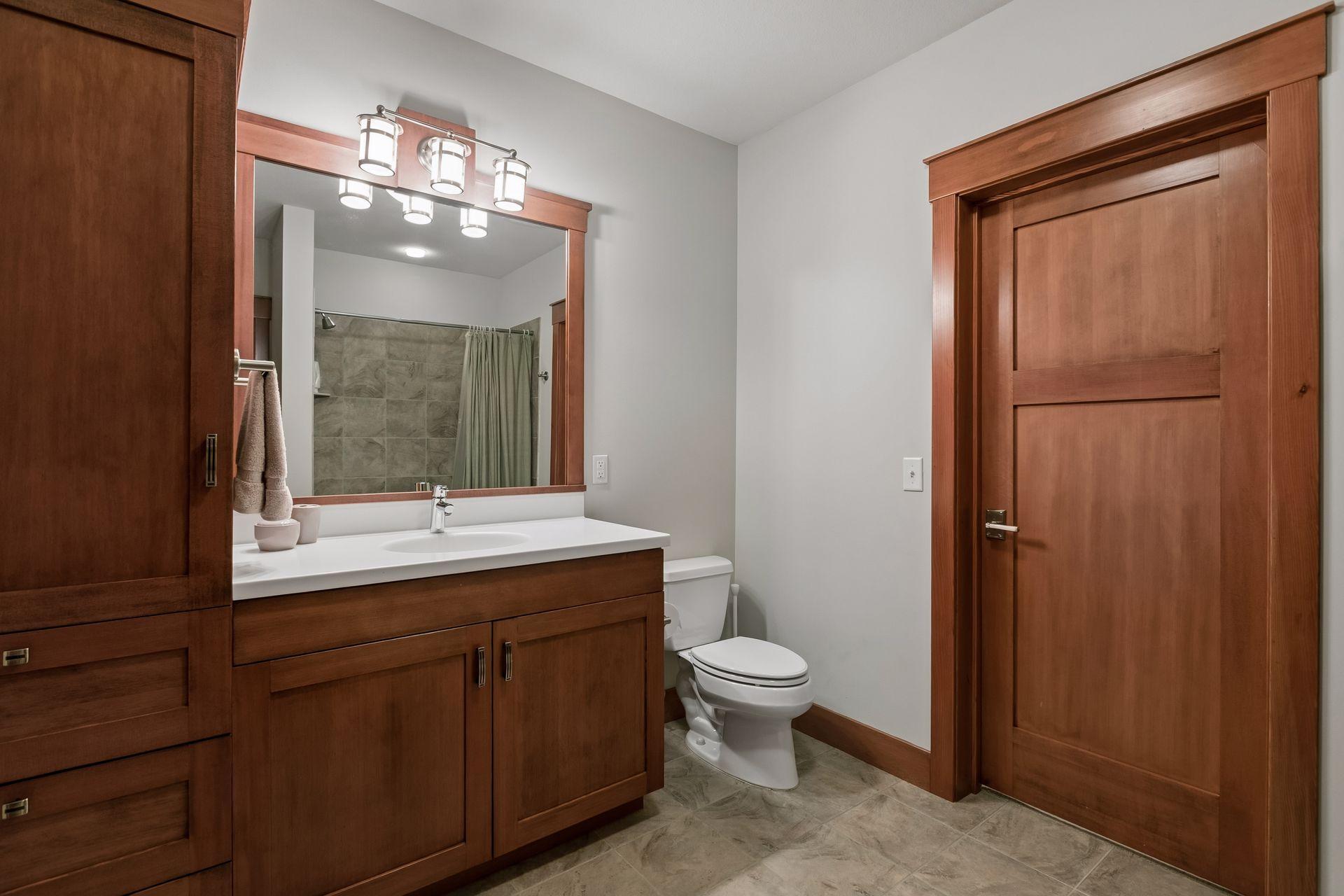 Lower-level full bath serves as a private en suite to the fourth bedroom while also offering convenient hallway access.