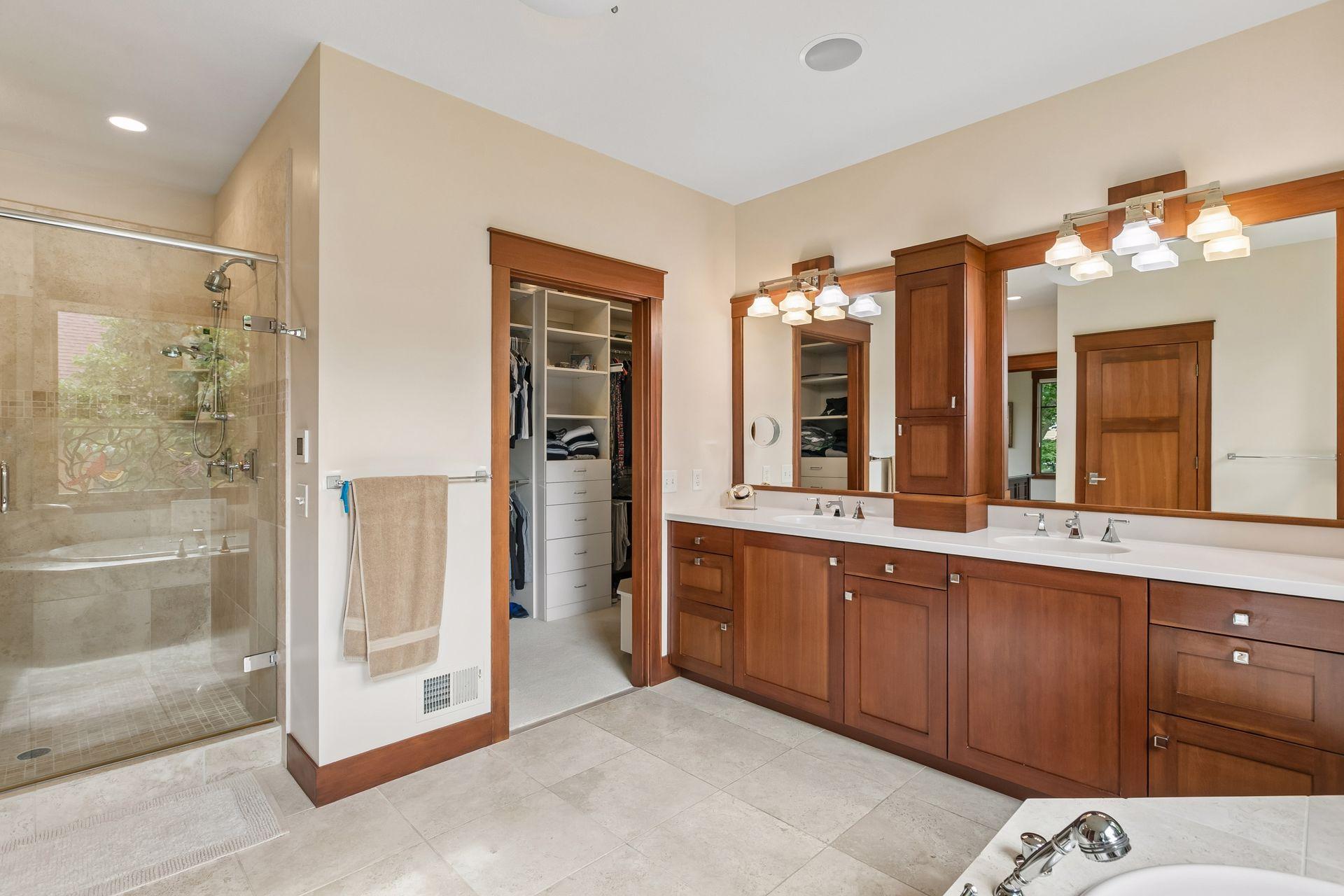 Primary bath with walk-in shower and direct access to the spacious walk-in closet.