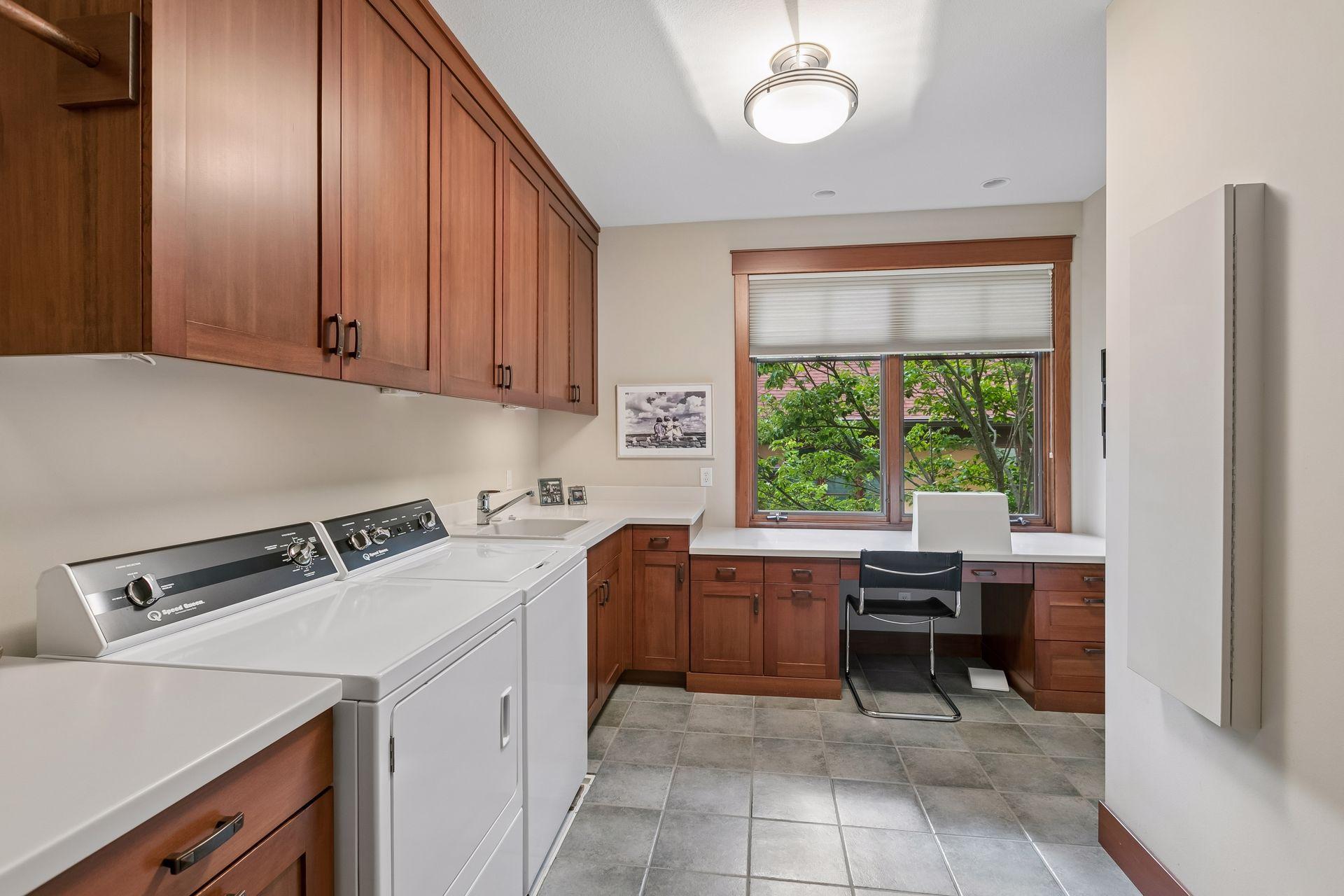 Convenient upper-level laundry room with direct access from the primary walk-in closet and hallway.
