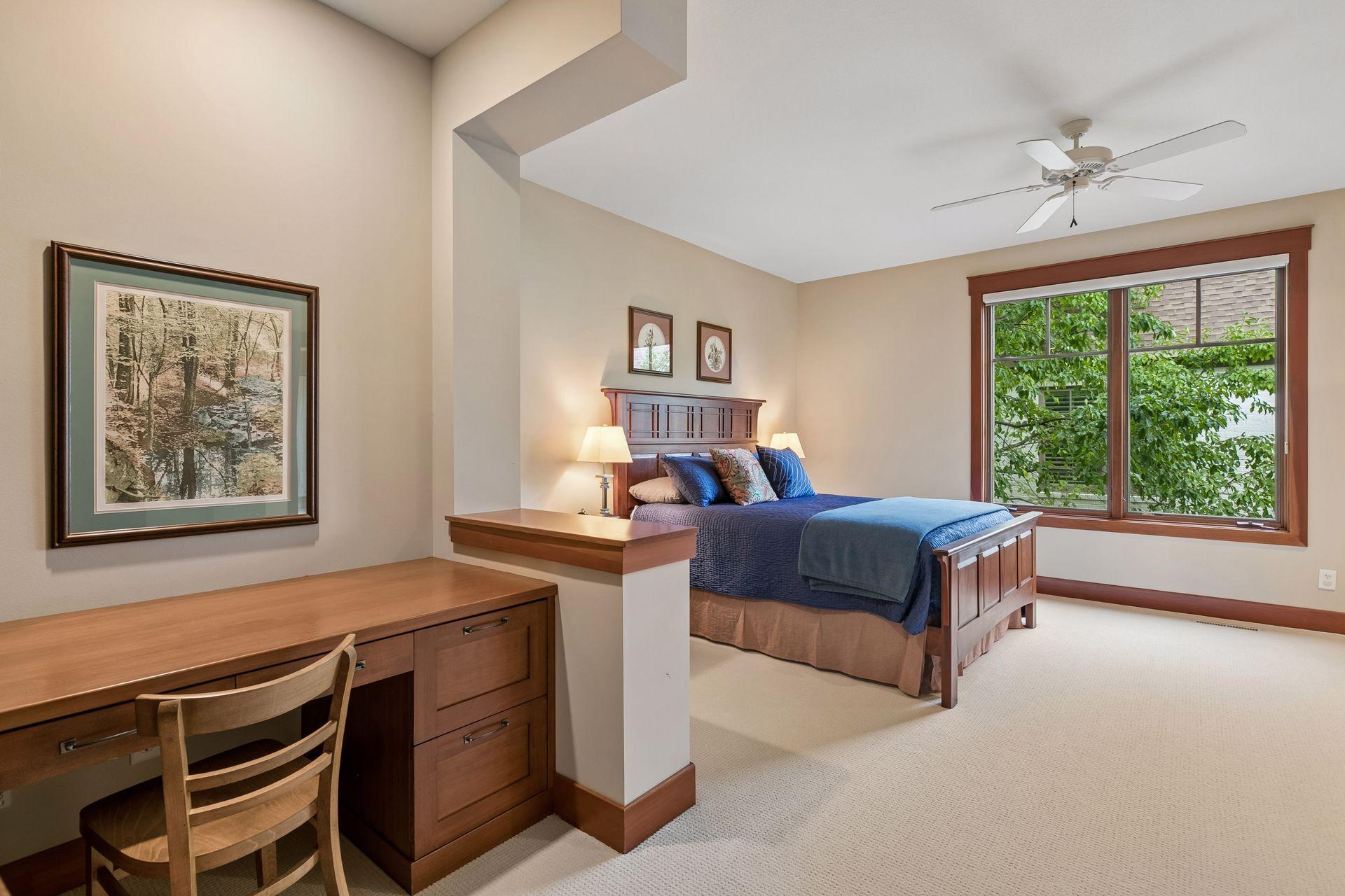 Bedroom 2 offers custom built-ins, including a desk and bookcases, plus a walk-in closet.