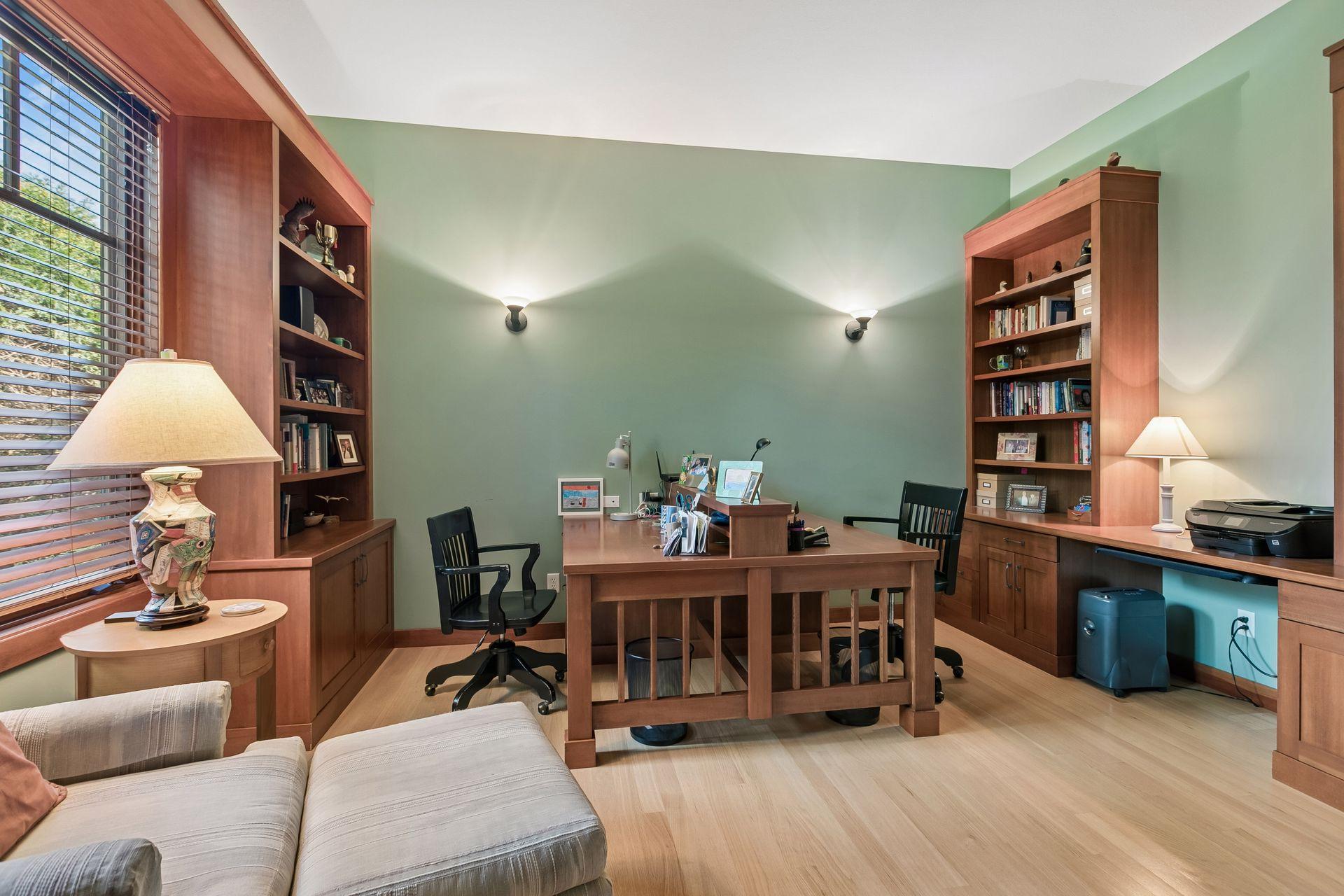 Main floor office with built-in desks and custom cabinetry.