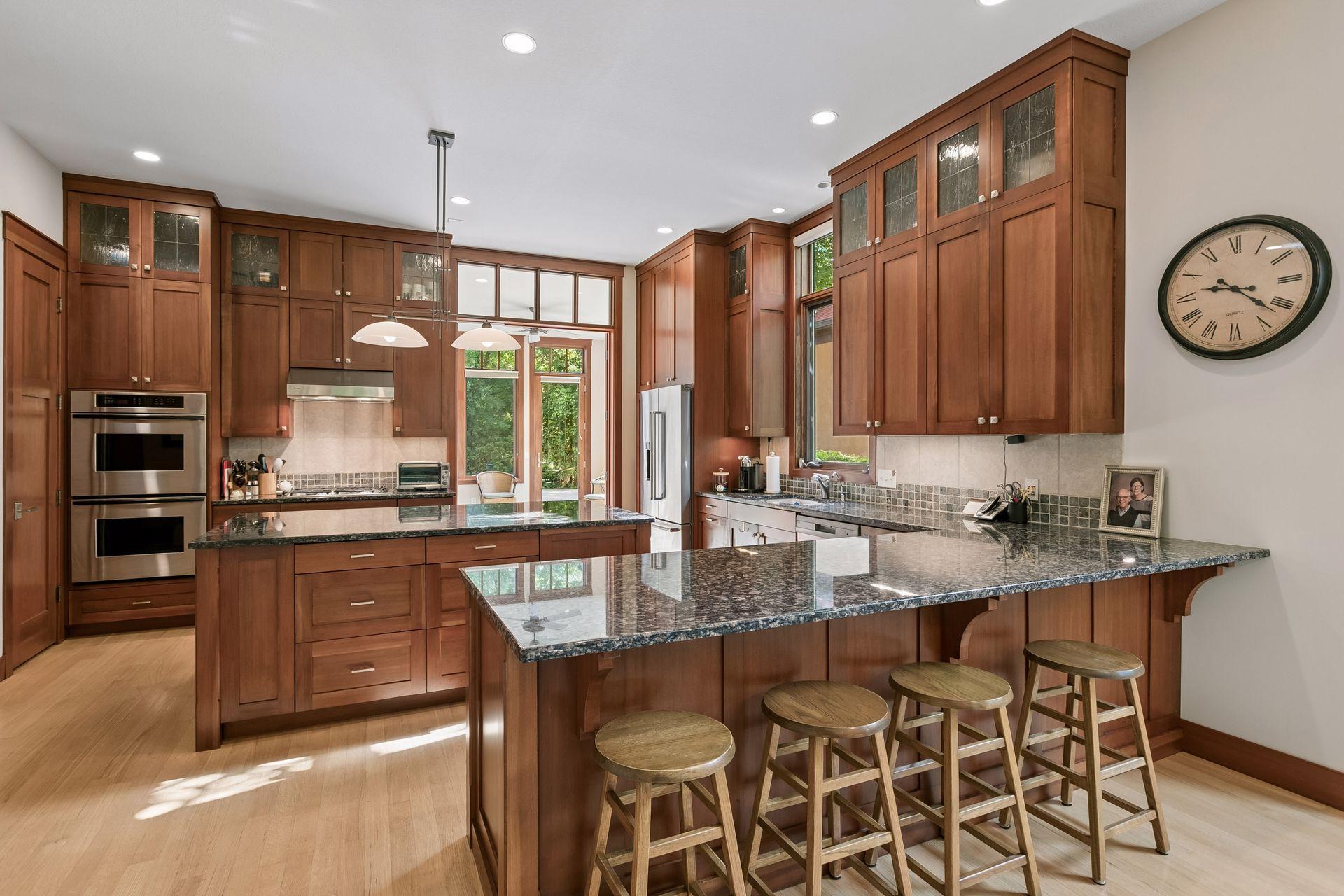 Gourmet kitchen with granite countertops and breakfast bar.