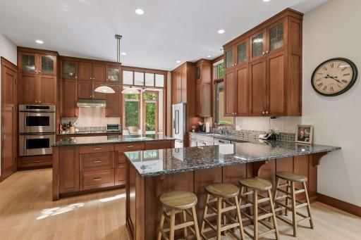 Gourmet kitchen with granite countertops and breakfast bar.