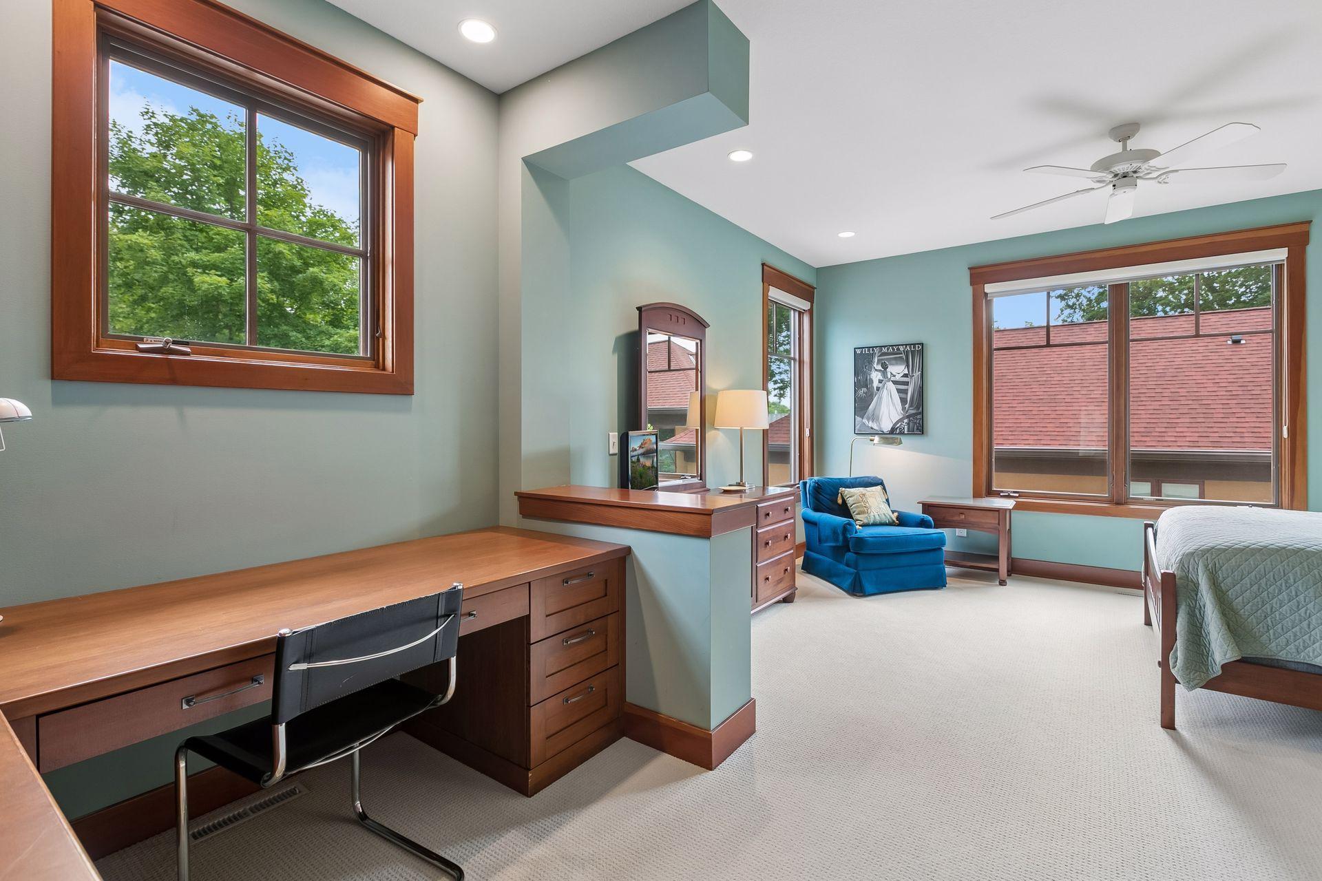 Bedroom 3 featuring custom built-in desk, bookcases, and a walk-in closet.