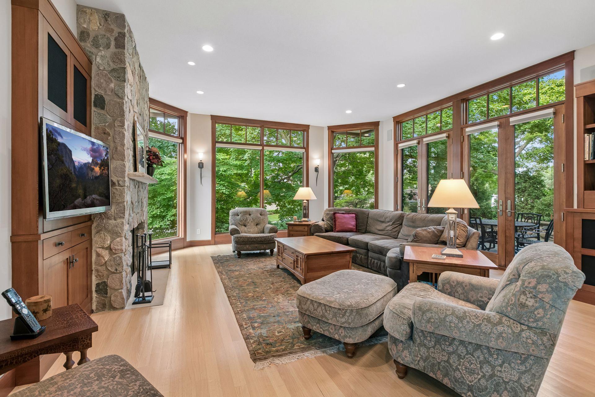 Family room with floor-to-ceiling windows and hardwood floors.