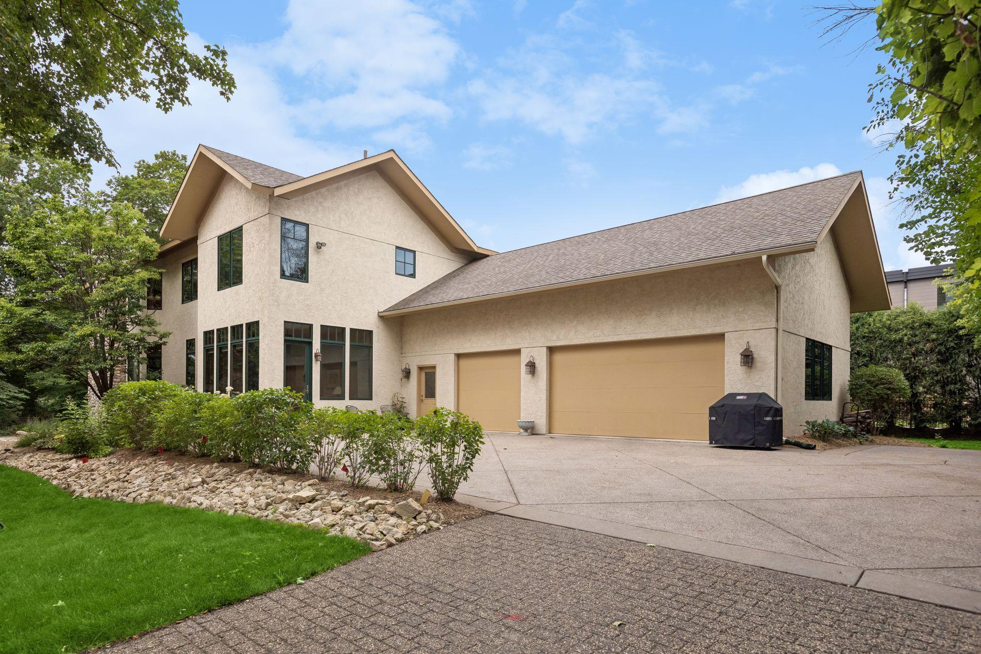 Insulated three-car garage with epoxy flooring, concrete driveway with access to shared driveway easement.