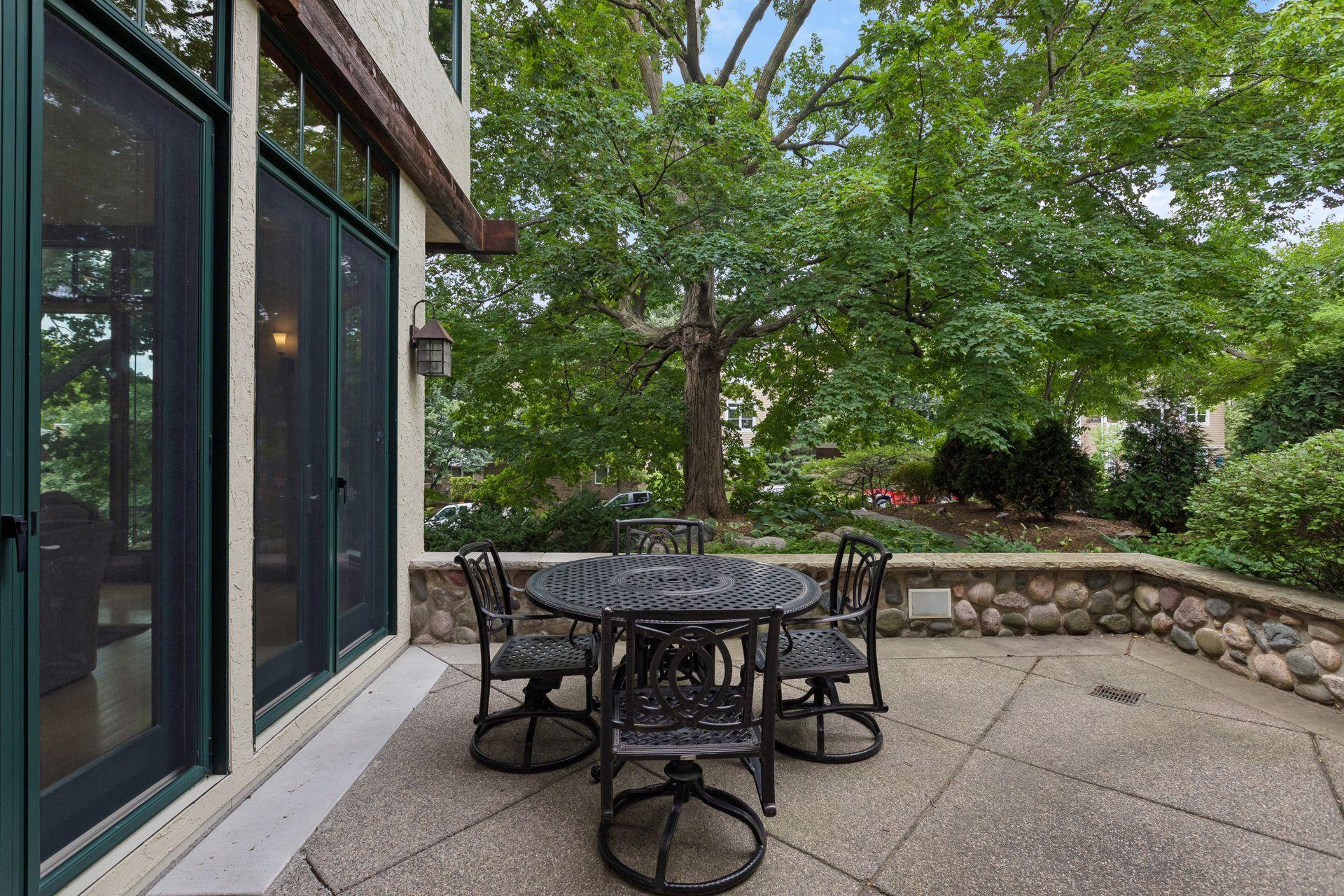 Inviting front patio nestled among the trees, offering a peaceful outdoor retreat.