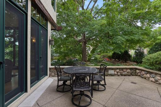 Inviting front patio nestled among the trees, offering a peaceful outdoor retreat.
