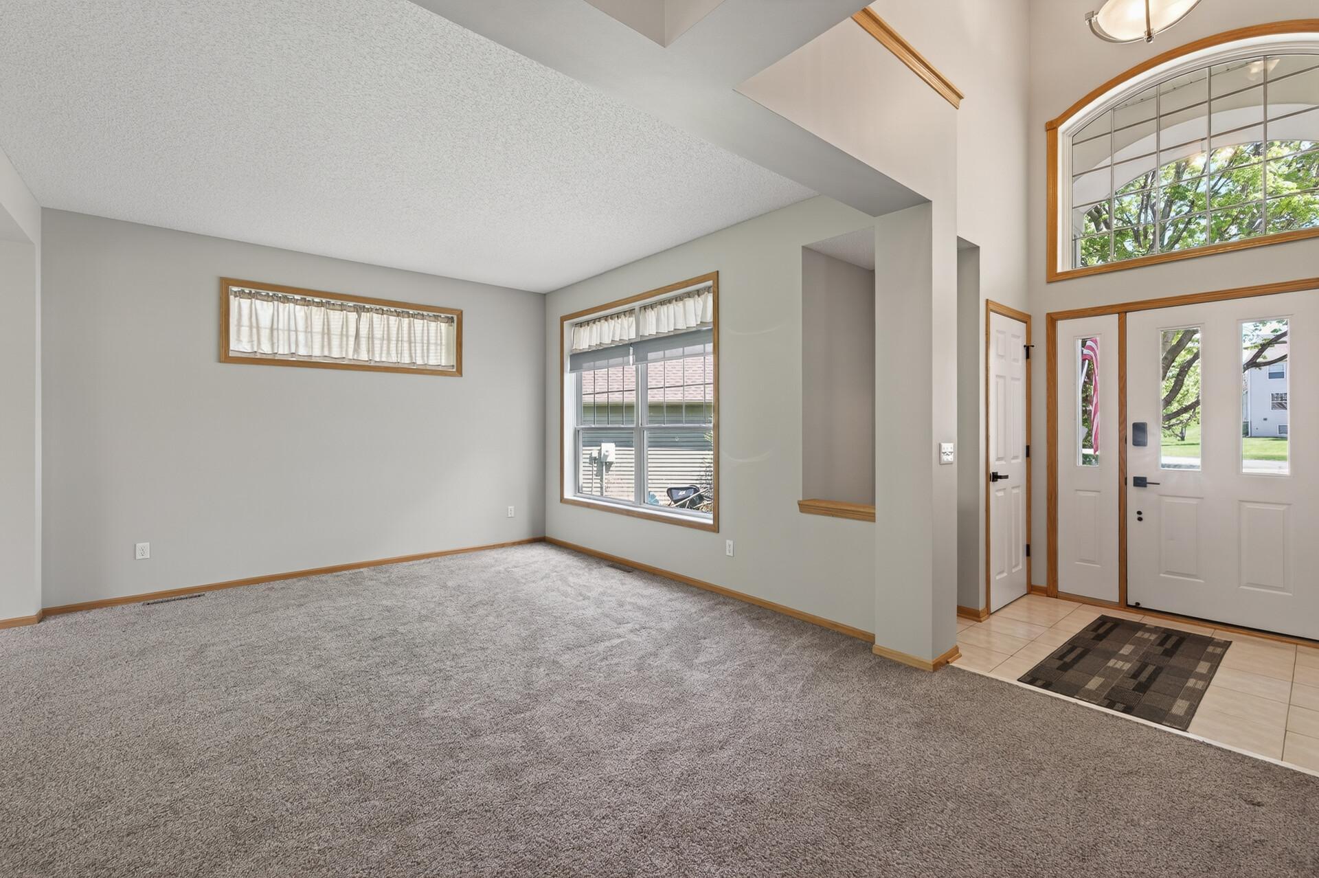 Open-concept main level living space with dramatic ceiling height and flexible layout options.