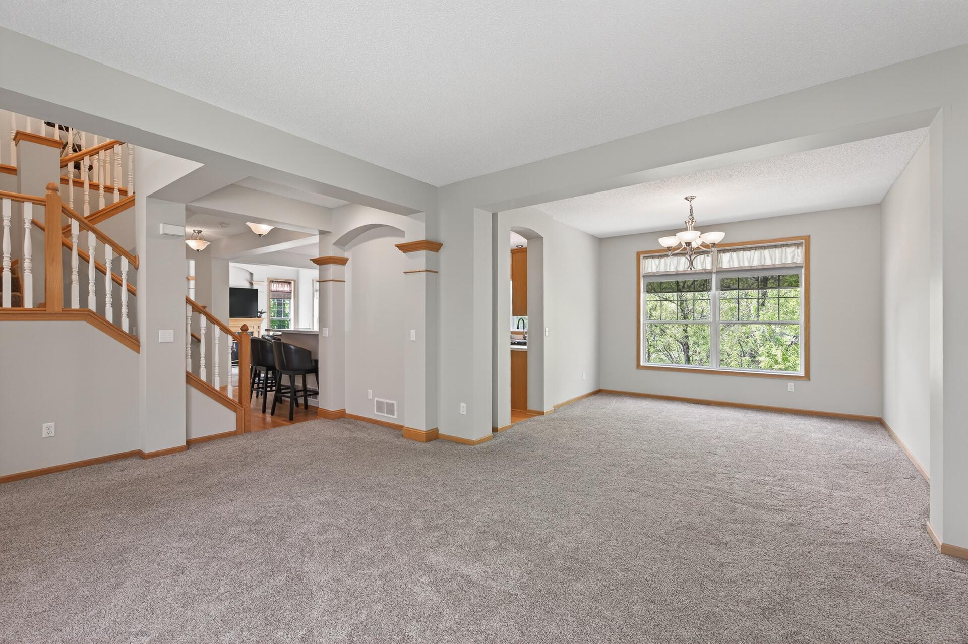 Expansive living area featuring large windows and seamless flow into adjoining spaces.