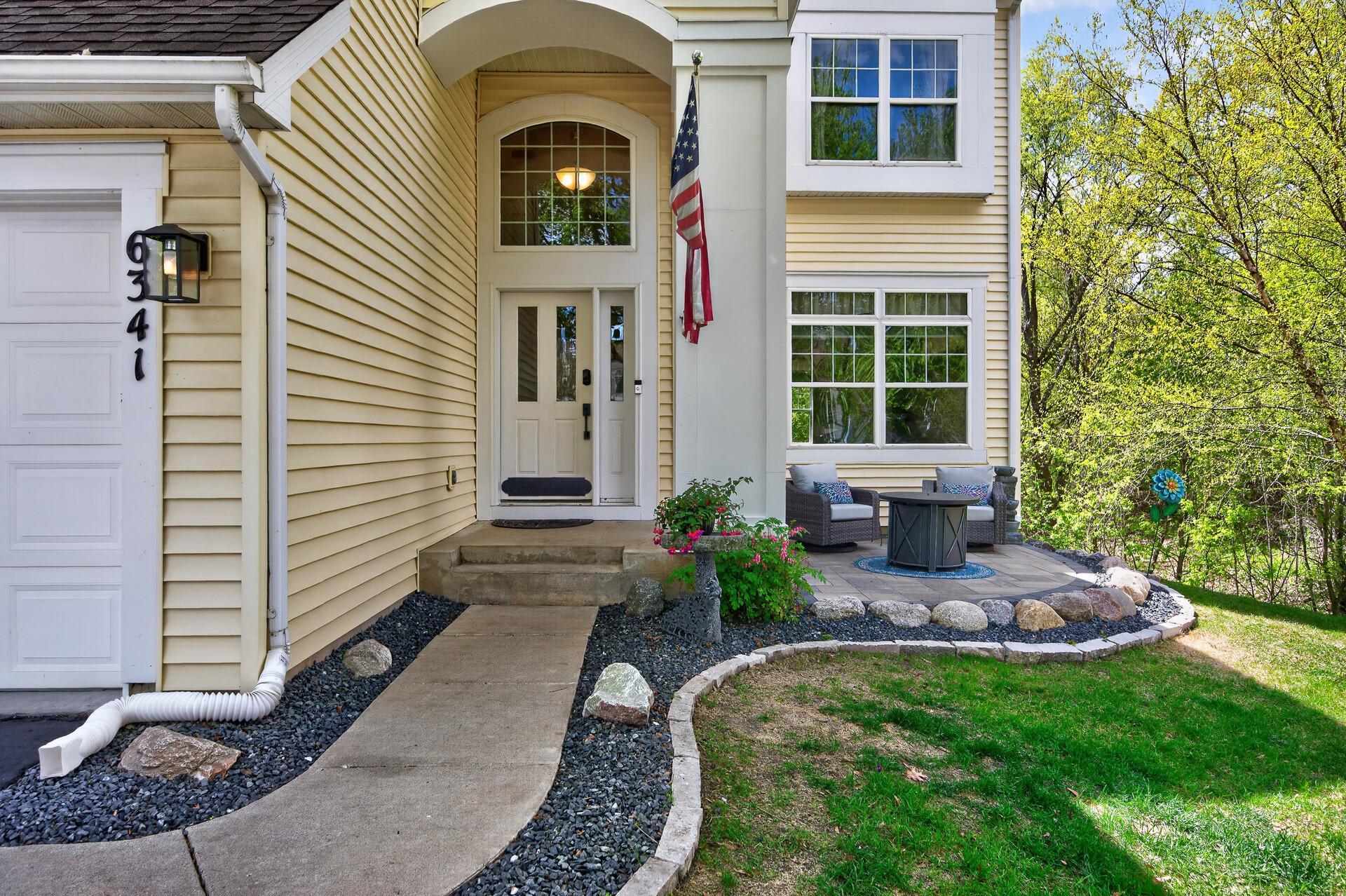Inviting front patio and grand two-story entry create a warm first impression.