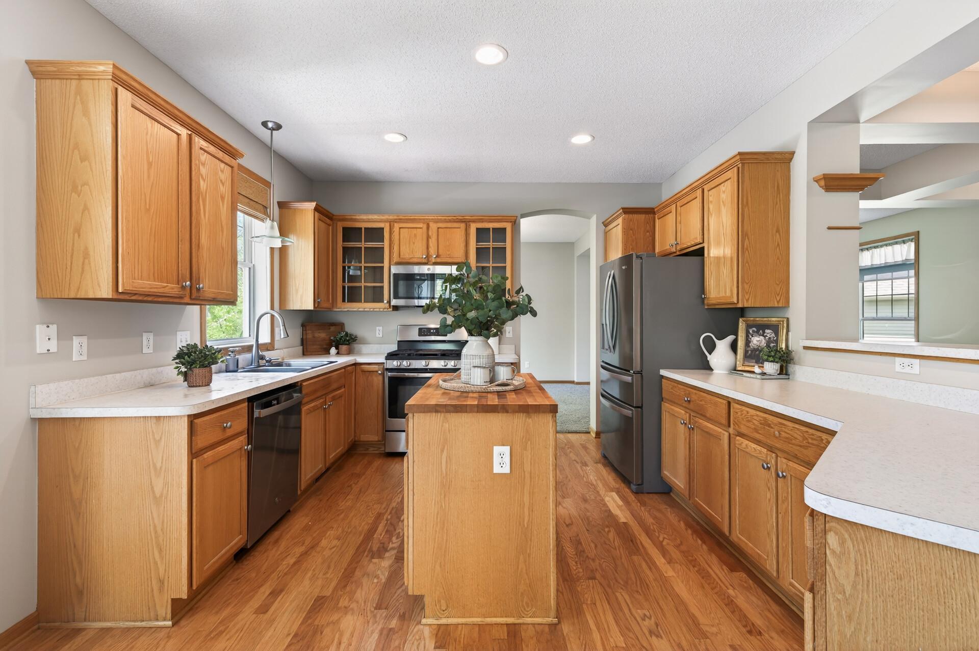 Spacious kitchen layout with center island, breakfast bar seating, and ample storage throughout.