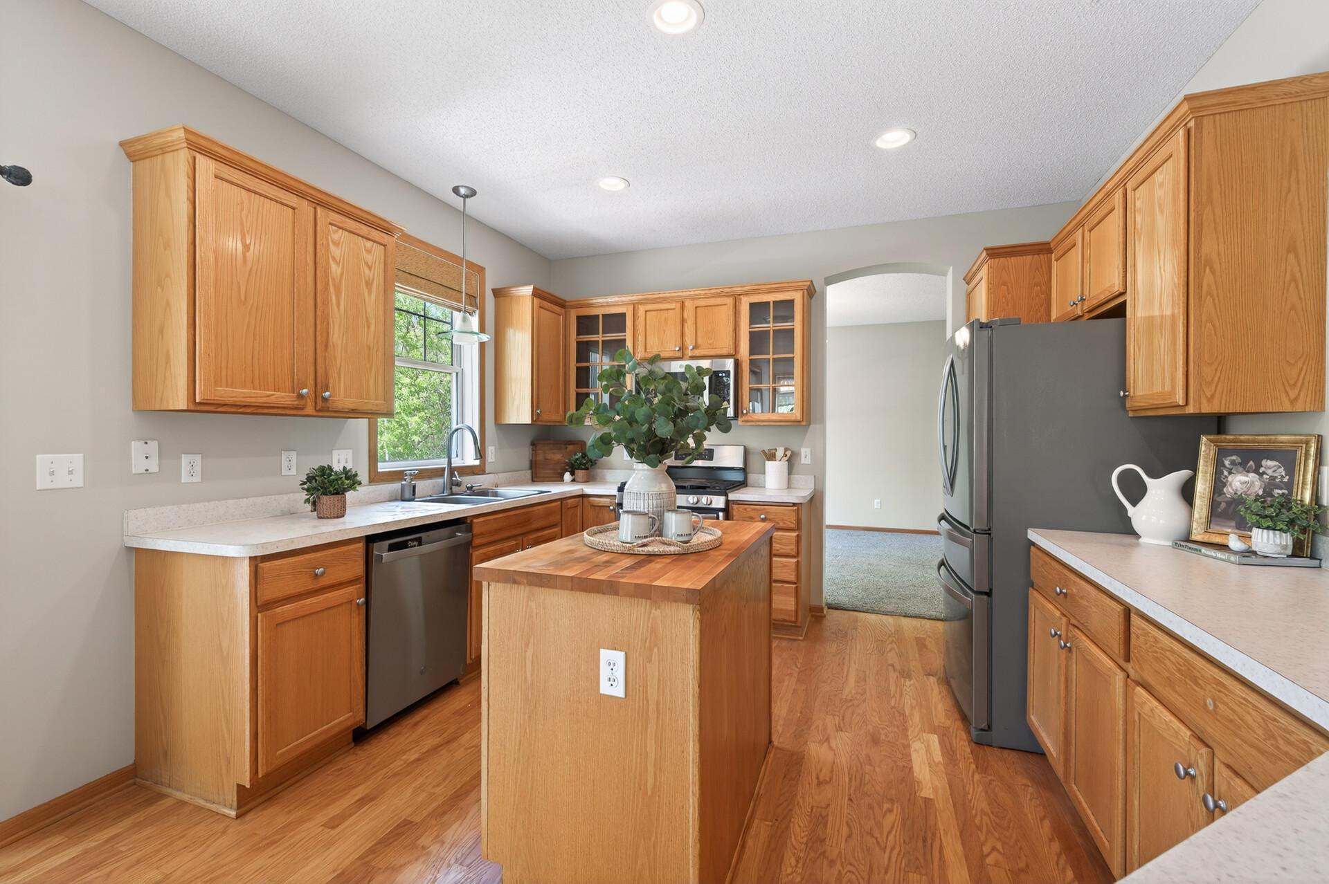 Sun-filled kitchen with hardwood flooring, generous prep space, and easy access to adjoining living areas.