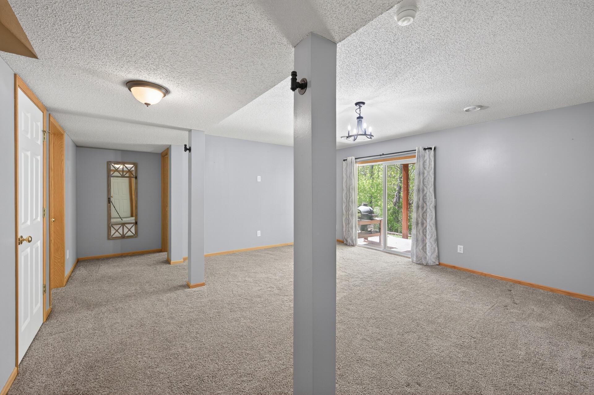 Expansive lower-level family room with walkout access and endless entertaining possibilities.