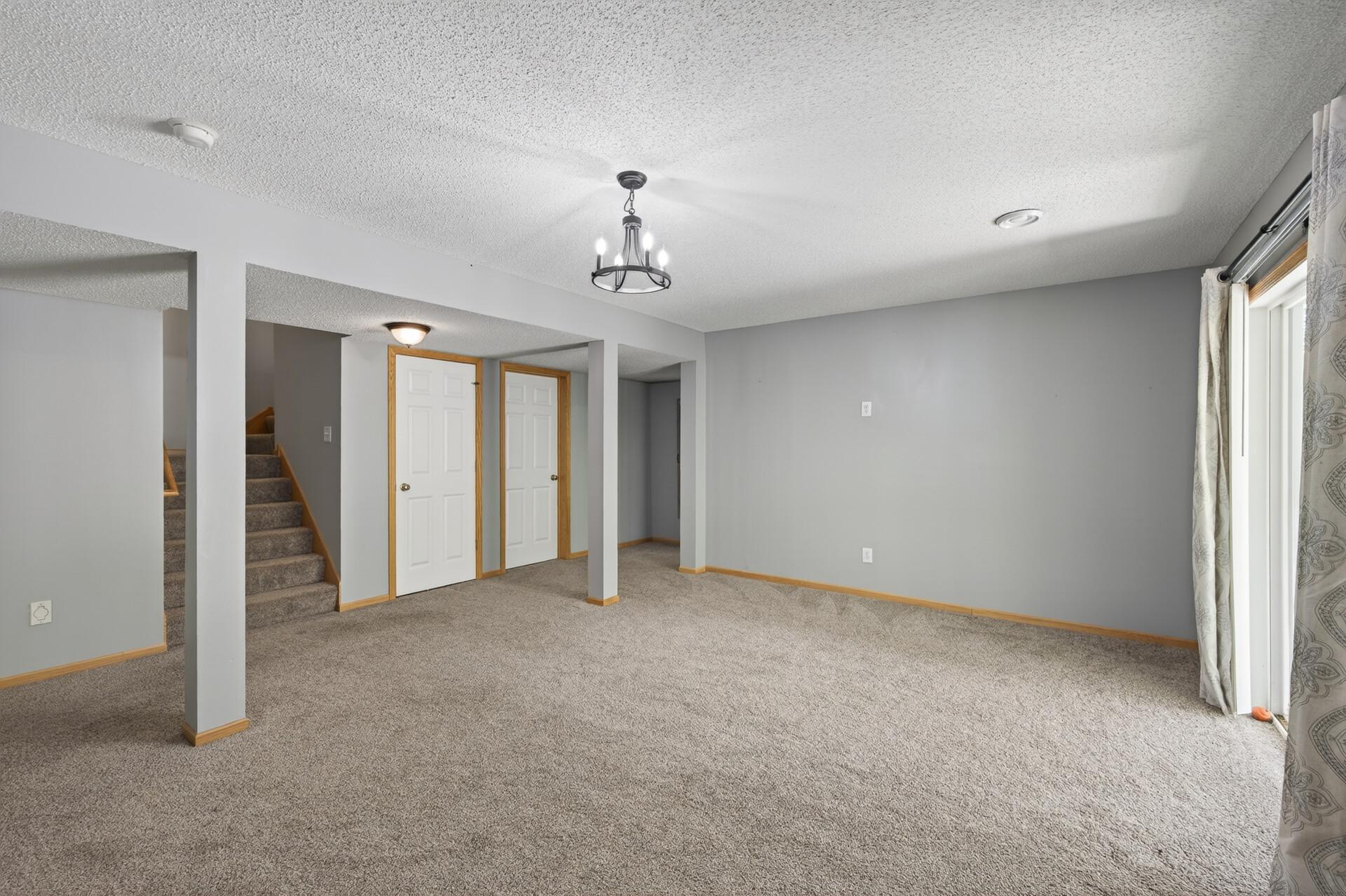 Large walkout lower-level recreation space with updated finishes and versatile open layout.