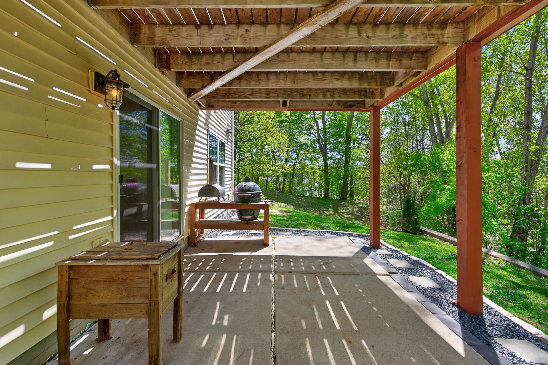 Covered walkout patio area ideal for outdoor dining, relaxing, or entertaining.