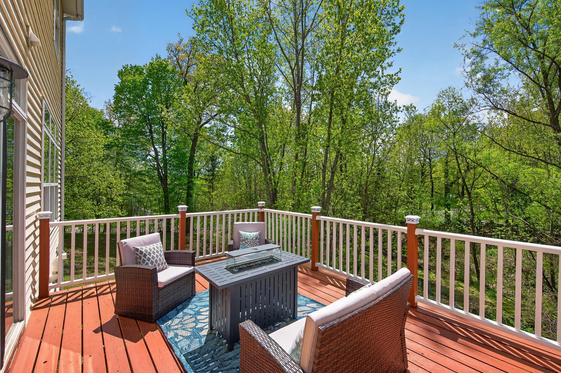 Expansive maintenance-free deck overlooking mature trees and peaceful backyard views.