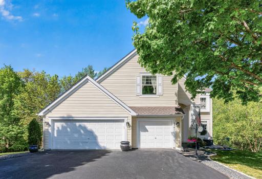 Stunning two-story exterior with mature trees, expansive driveway, and 3-car garage.