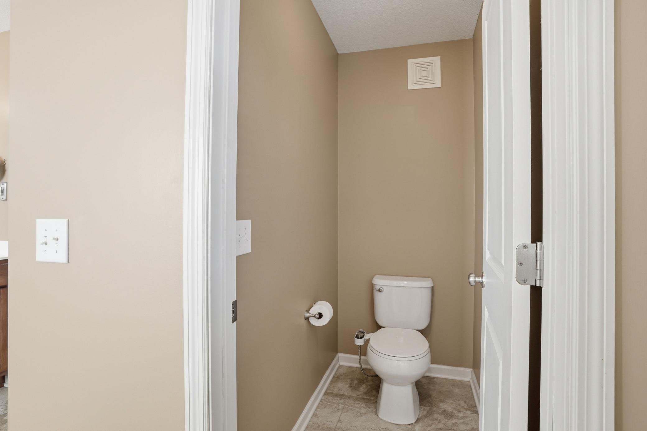 Private bathroom tucked away from the rest of the primary bath.