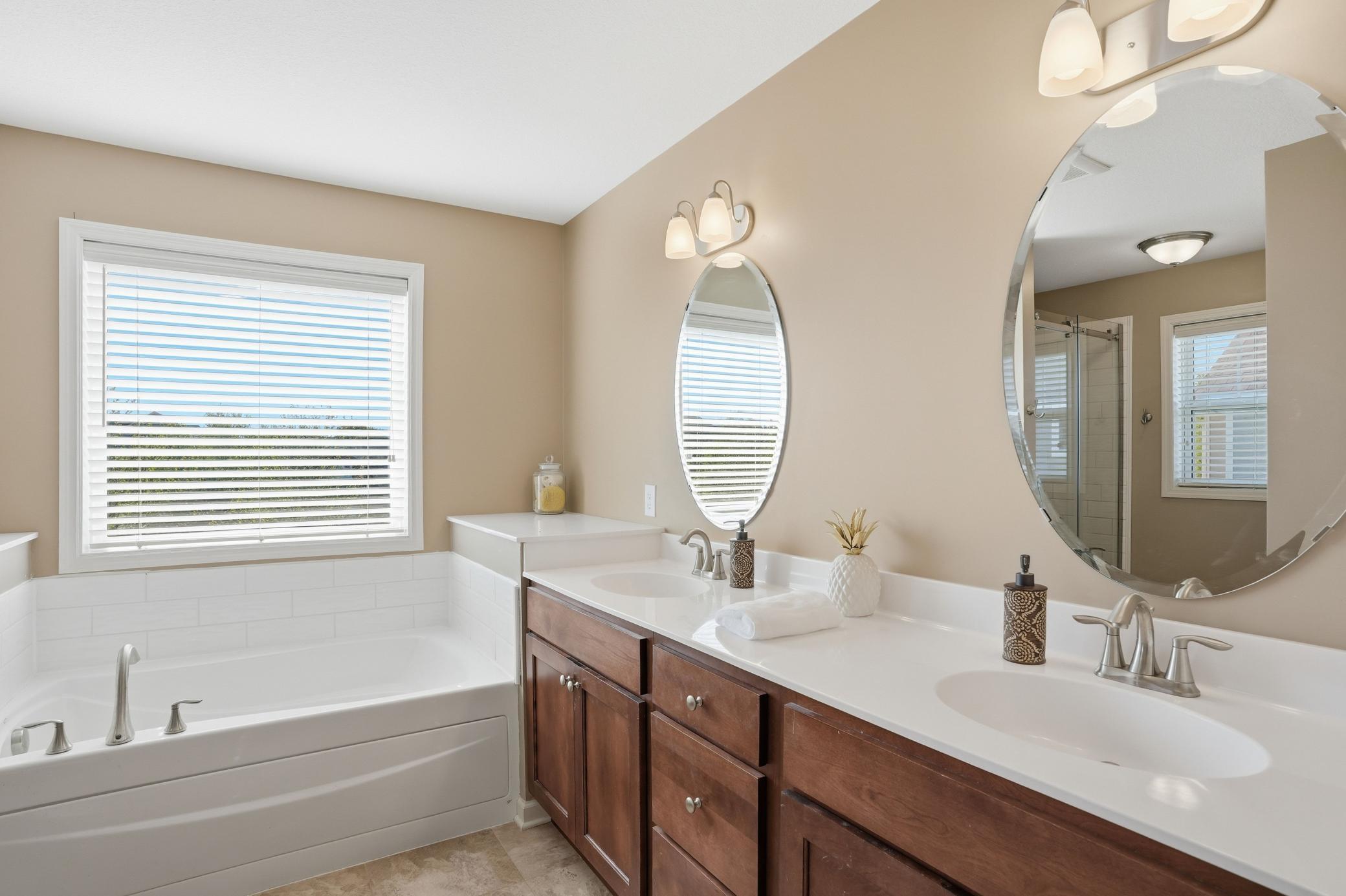 Double vanities, a soaking tub, and natural light that makes mornings feel a little easier.