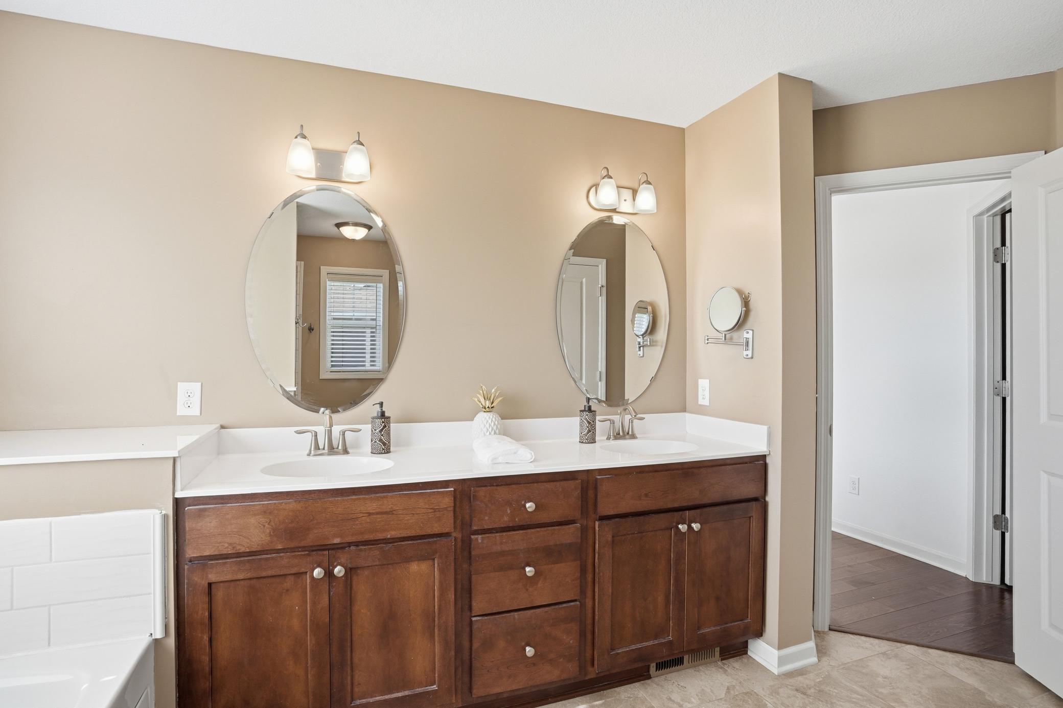 Warm finishes and plenty of counter space give this bathroom a calm, everyday luxury feel.