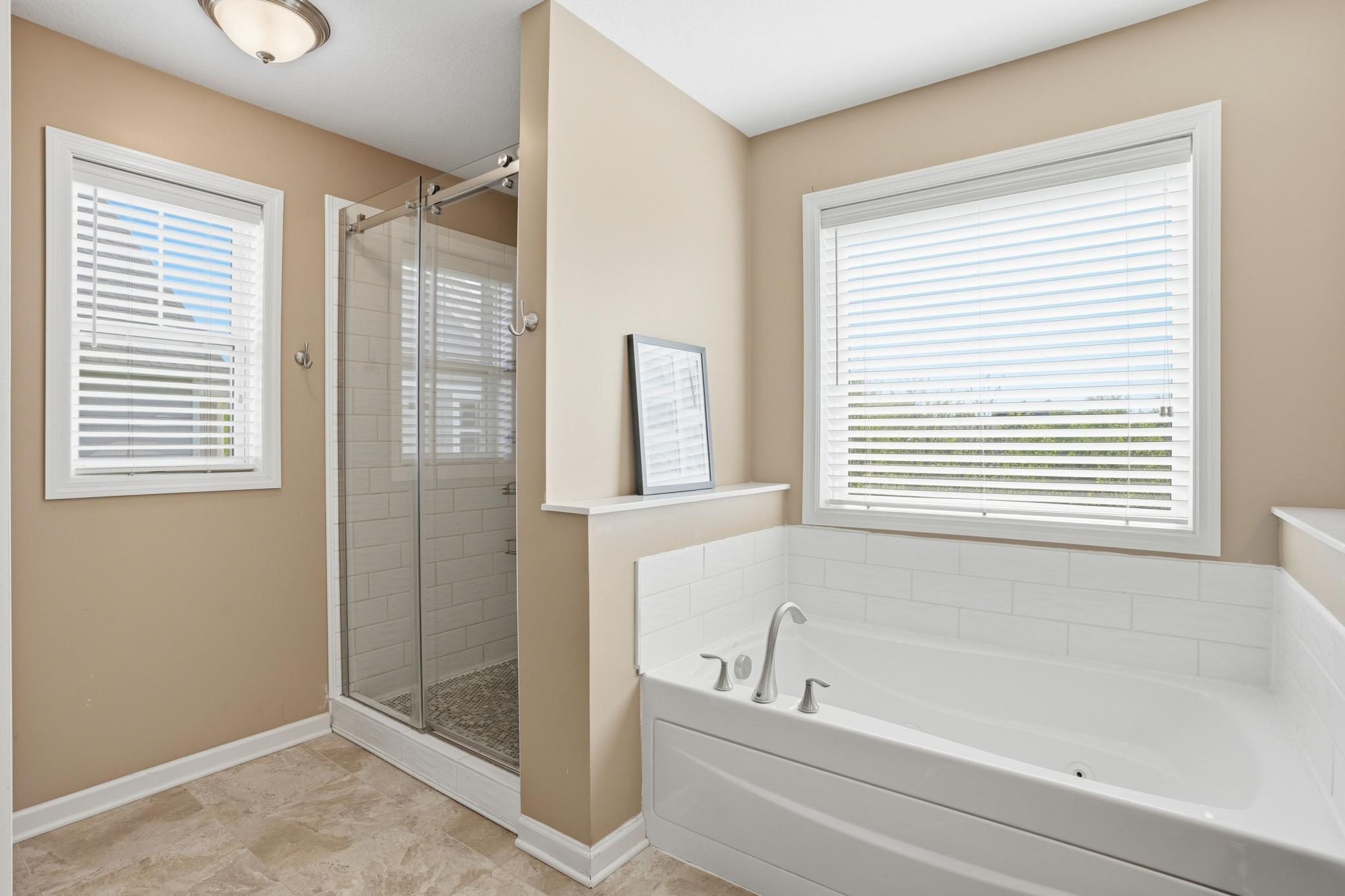 Separate tub and glass shower setup so no one has to compromise.