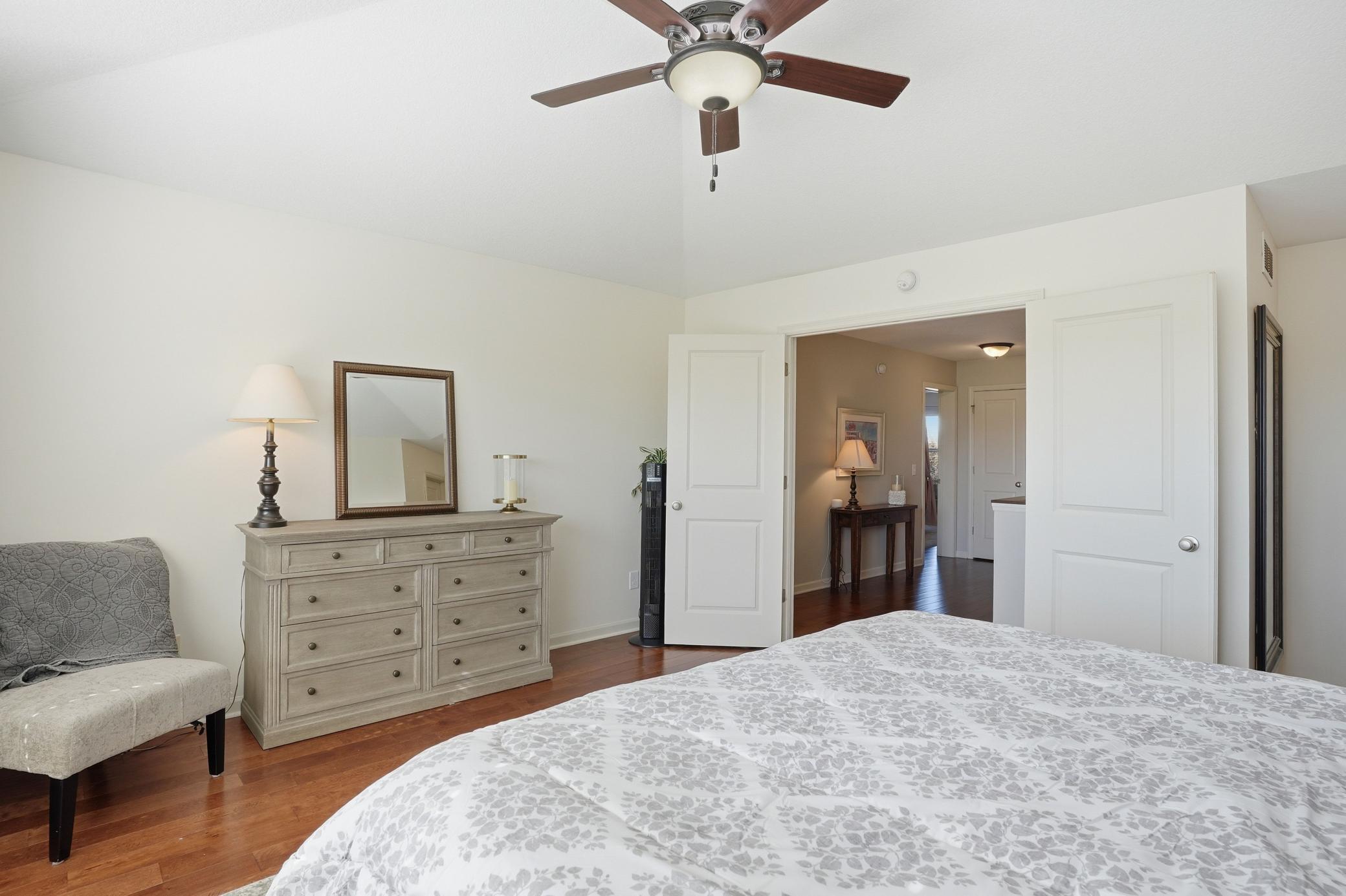 Vaulted ceilings and oversized windows make this primary bedroom feel bright and airy.