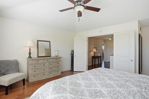 Vaulted ceilings and oversized windows make this primary bedroom feel bright and airy.