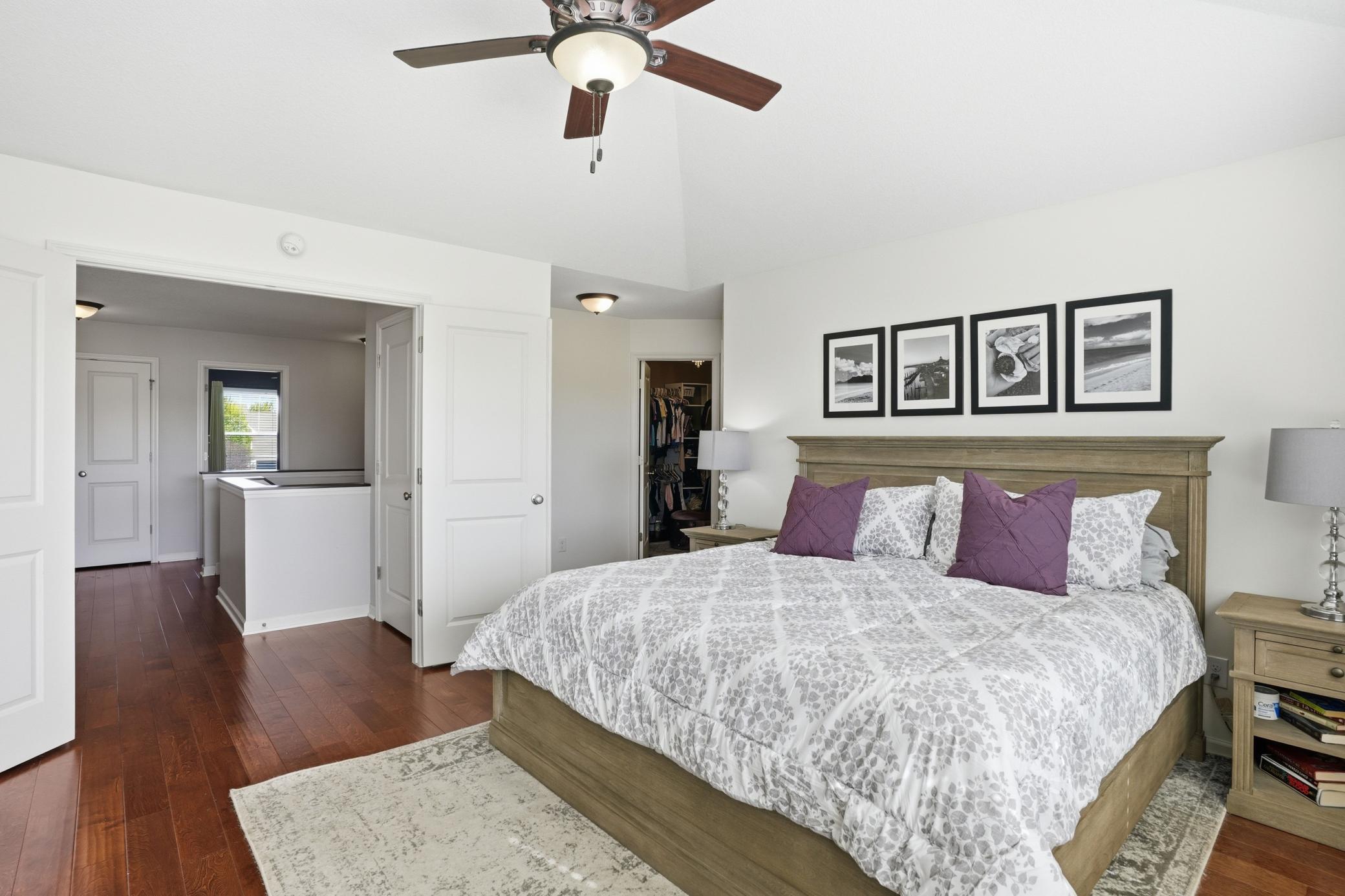 Hardwood floors, soaring ceilings, and a walk-in closet complete the primary suite.