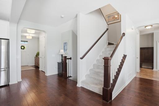 Elegant staircase with rich wood railings and fresh neutral finishes.