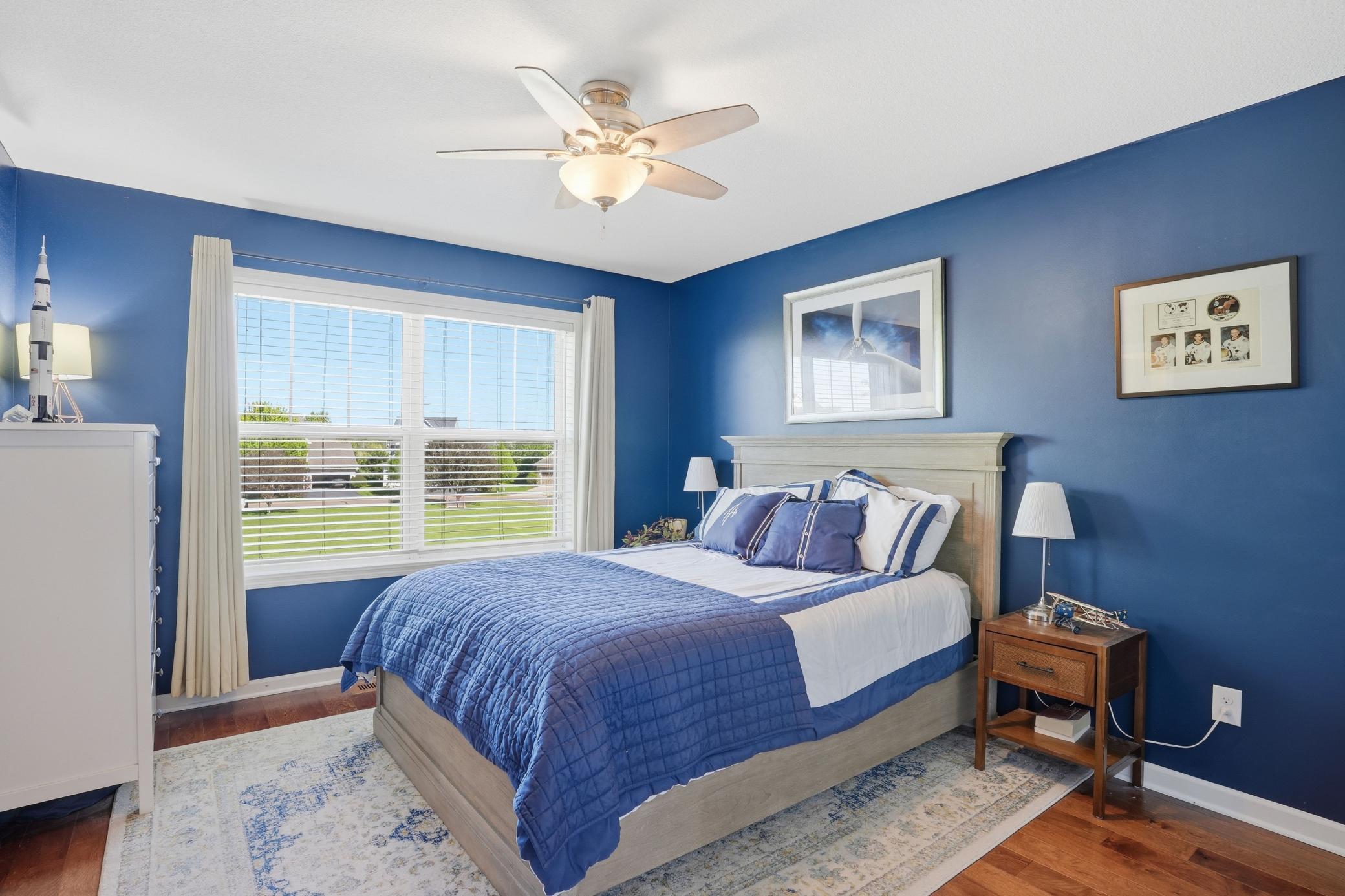 Bold blue walls and aviation details make this bedroom feel fun without sacrificing style.