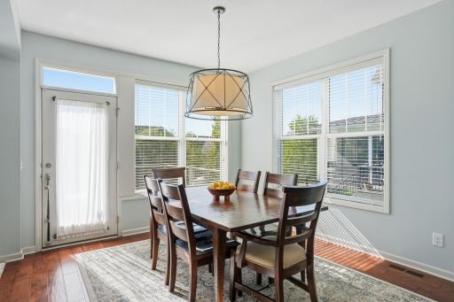 Sunny dining area with views overlooking the backyard.