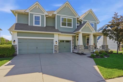 Beautiful exterior with charming front porch and spacious 3-car garage.