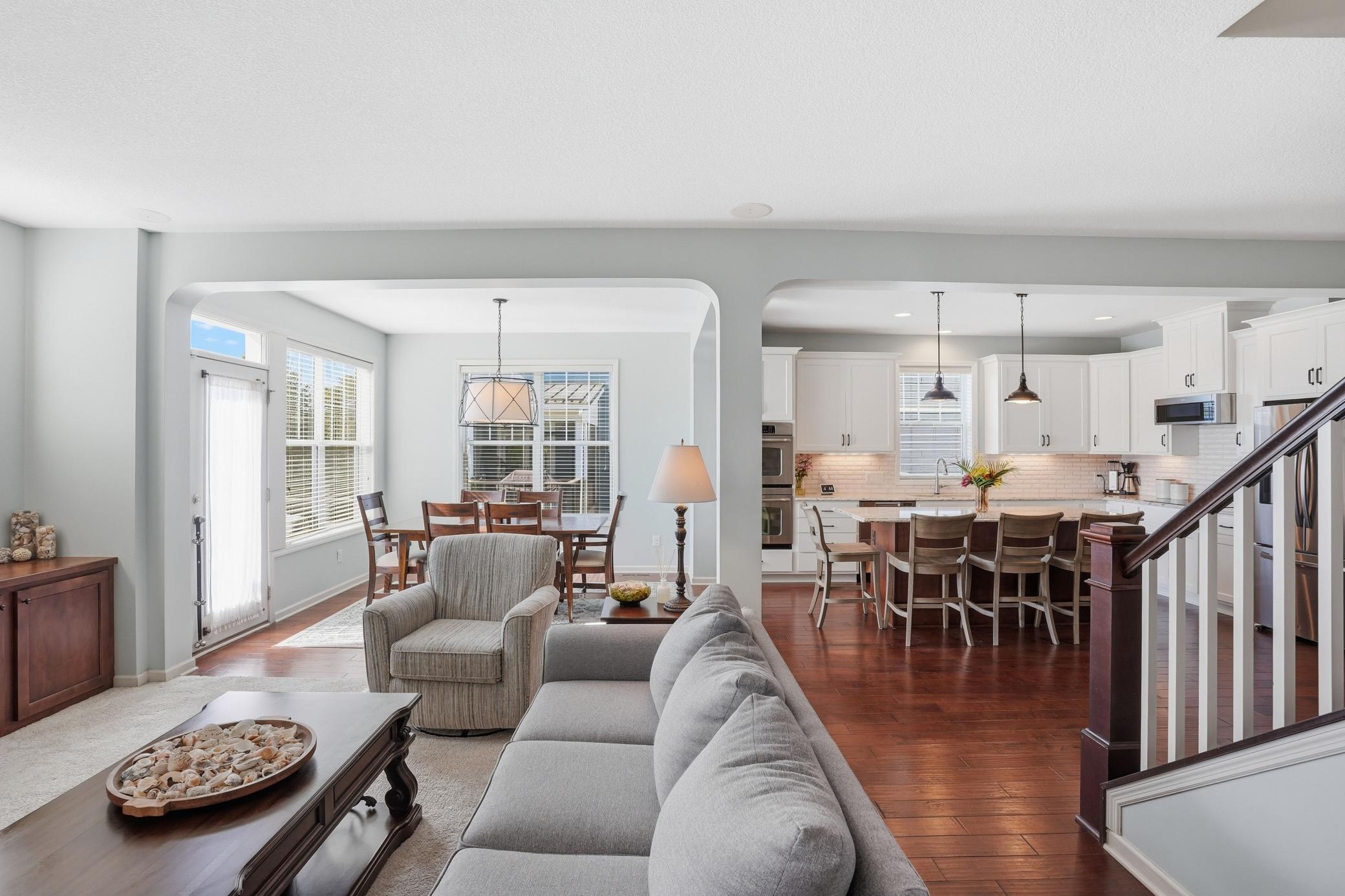 Warm hardwood floors and inviting gathering spaces throughout.